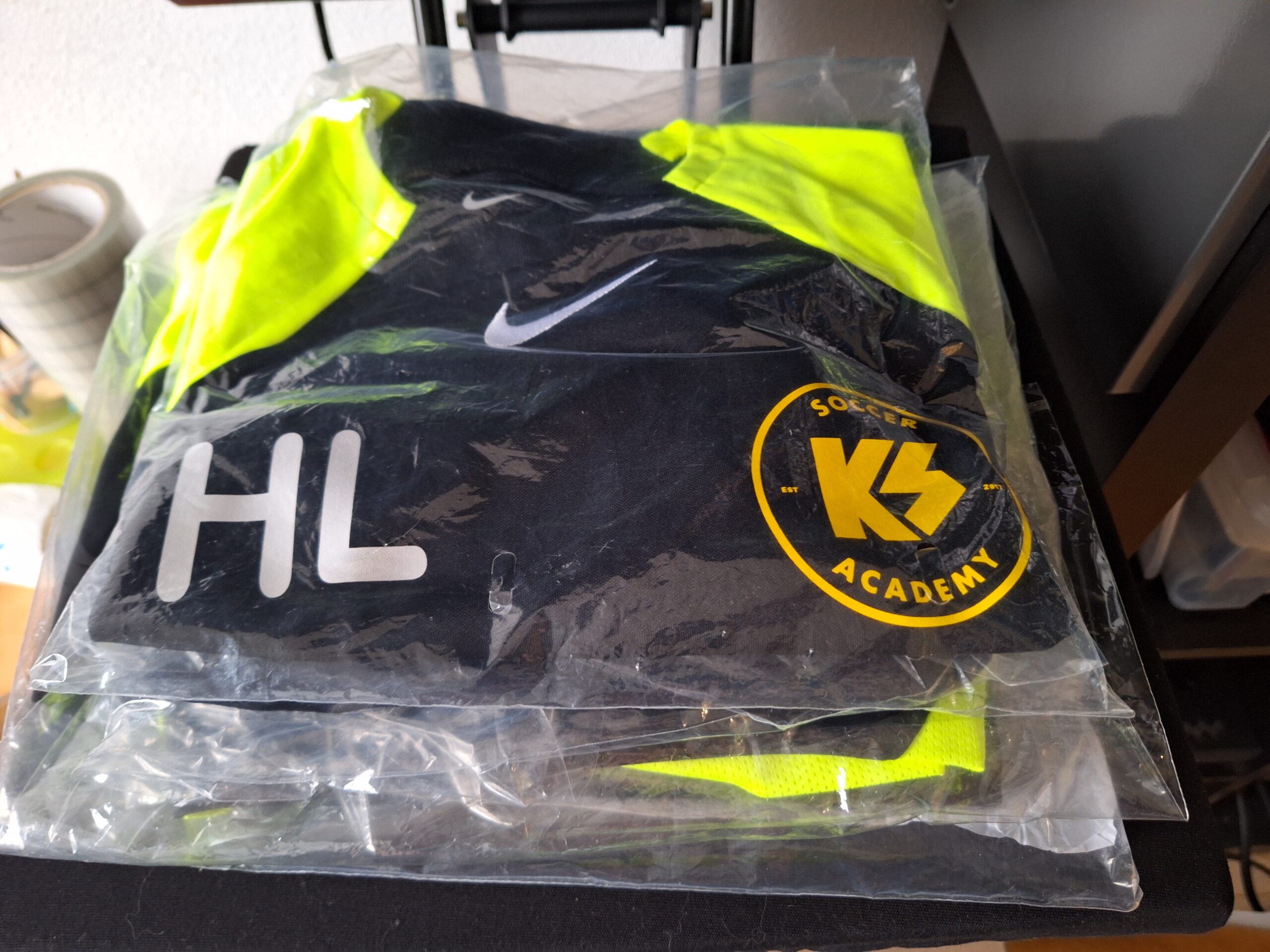 a black and yellow shirt in a plastic bag 038 Design Zwolle